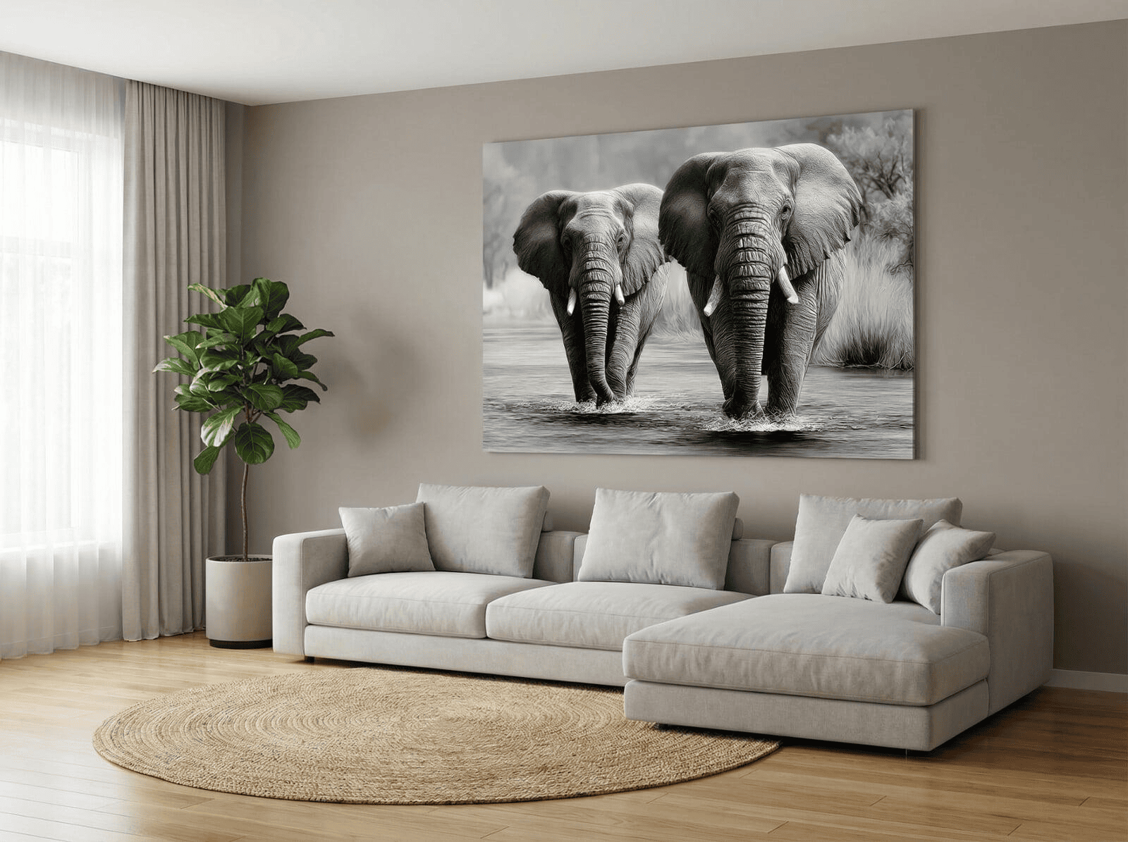 A wide-angle shot of a minimalist, luxury living room featuring a light-grey sectional sofa. Above the sofa, an oversized, high-contrast black and white African elephant portrait is centered on a neutral taupe wall. The room includes a large potted fiddle-leaf fig and a natural jute rug.